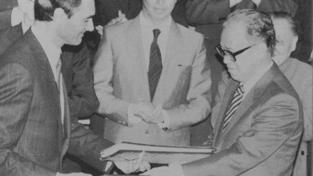 Portugese Prime Minister Anibal Cavaco Silva and Chinese Premier Zhao Ziyang exchange signed copies of an agreement under which Portugal will return Macao to Chinese control in 1999. April 13, 1987. 