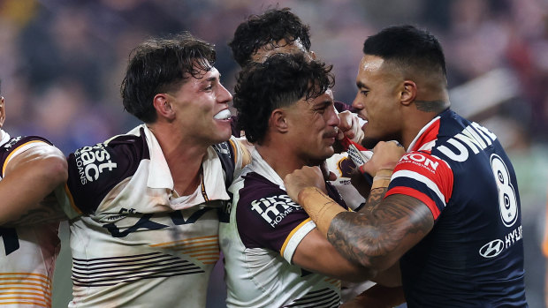 Spencer Leniu (right) of the Roosters exchanges heated words with Kotoni Staggs of the Broncos in Las Vegas.