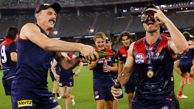 Jake Lever and Alex Neal-Bullen celebrate their premiership win on the Optus Stadium turf.