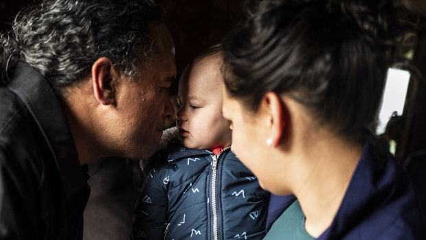 A child is welcomed with a hongi, the traditional Maori nose-pressing greeting, in Auckland.