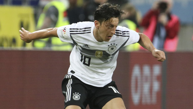 Controversial: Mesut Ozil playing for Germany in a friendly against Austria earlier this year.