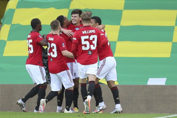 Harry Maguire (centre) is swamped by teammates after scoring a last-gasp winner in extra time.