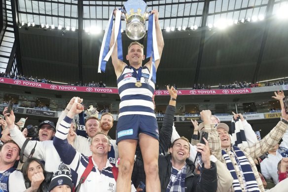 Cats’ captain Joel Selwood celebrates with the crowd after winning the 2022 AFL grand final, shortly before announcing his retirement from the sport. 