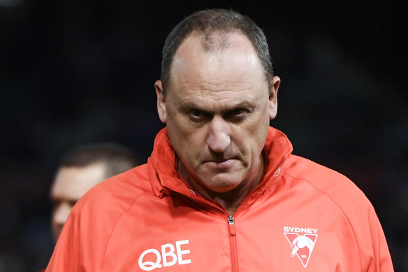 John Longmire is out as Swans coach but will stay on at the club.