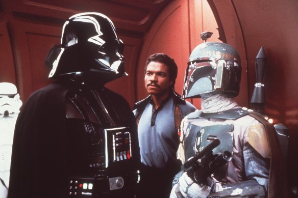 Billy Dee Williams as Lando Calrissian, centre, flanked by Darth Vader and Boba Fett in The Empire Strikes Back.
