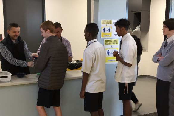 Homestead Senior Secondary College students lining up for a free school lunch.