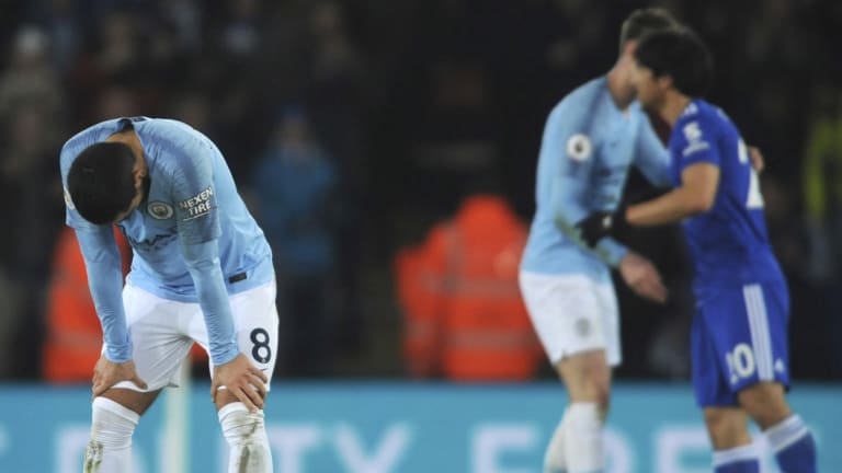 Manchester City's Ilkay Gundogan (left) reacts to the loss to Leicester.