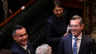 Treasurer Dominic Perrottet is congratulated by colleagues in the NSW Parliament on Tuesday after reading his annual budget speech.