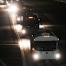 A convoy of buses moves along Interstate Highway 10 after leaving the Marine Corps base in Twentynine Palms, California.