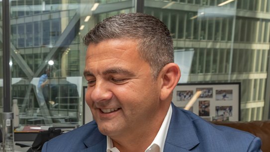 Xanthi FC owner Bill Papas watches on as Tony Popovic puts pen to paper with the Greek club.