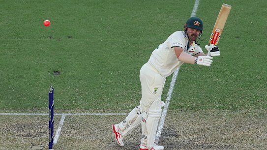 Travis Head smacks the pink ball in Adelaide.