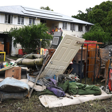 A large pile of water-damaged items in front of a flooded house in the Townsville suburb of Hermit Park on Wednesday.