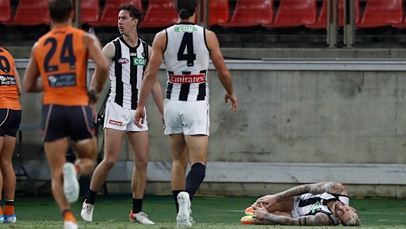 Jeremy Howe, right, clutches at his knee after a collision with Jacob Hopper.