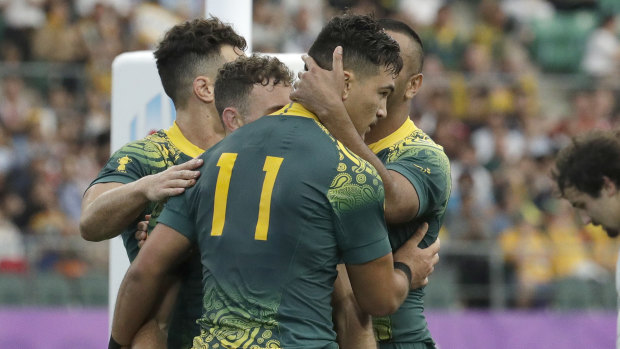 Jordan Petaia (No.11) is congratulated after scoring a try on debut for the Wallabies.