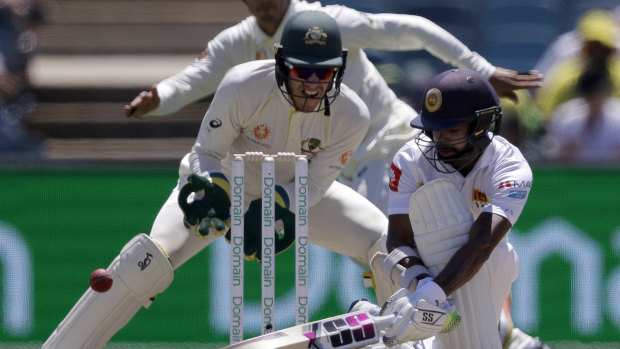 Dilruwan Perera sweeps in front of Tim Paine at Manuka Oval.