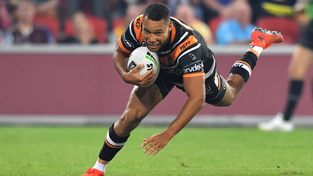 Moses Mbye of the Tigers scores a try during the Magic Round clash against Penrith Panthers at Suncorp Stadium in Brisbane.