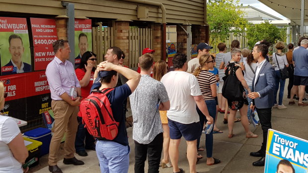 Battle lines - Labor candidate for Brisbane Paul Newbury (left) and LNP incumbent Trevor Evans work either side of the voting line at New Farm state school