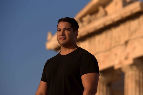 Marc Fennell seen by the Parthenon on his TV program, Stuff The British Stole.