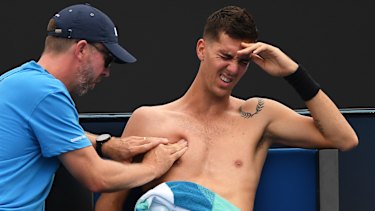 Familiar feeling: Thanasi Kokkinakis receives treatment during a match in January.