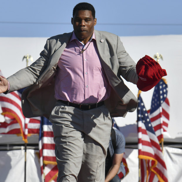 Herschel Walker, who is running for the Republican nomination to US Senate, takes on the stage during a rally for Georgia GOP candidates in March.