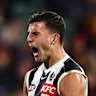 Nick Daicos celebrates kicking a goal.