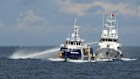 In this photo provided by the Philippine coast guard, a Chinese coast guard vessel, right, fires its water cannon at the Filipino vessel.