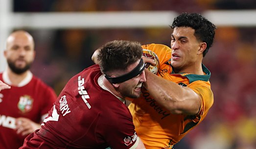 Joseph-Aukuso Suaalii of the Wallabies is tackled by Tom Curry.