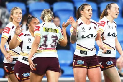 The Broncos celebrate a try in their NRLW win over the Titans.