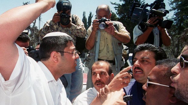 June 2000: Ben-Gvir raises his fist at Palestinian guards as Israelis march through traditionally Arab East Jerusalem.