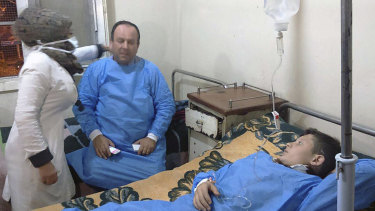 A photo released by the Syrian official news agency SANA, shows people receiving treatment at a hospital following a suspected chemical attack on Saturday.