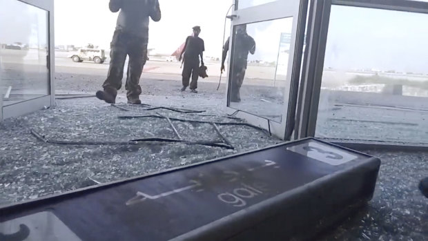 Glass and debris cover the damaged portion of the airport in Yemen’s southern city of Aden after an explosion.