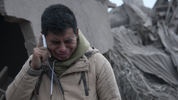 A man cries after seeing the condition of his neighbourhood, destroyed by the erupting Volcano of Fire, in Escuintla, Guatemala.