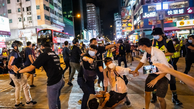 Undercover police in Hong Kong arrest activists at a Tiananmen Square vigil in June.