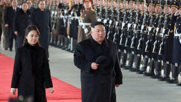 Kim Jong-un and his wife Ri Sol-ju at Pyongyang station before leaving for China.