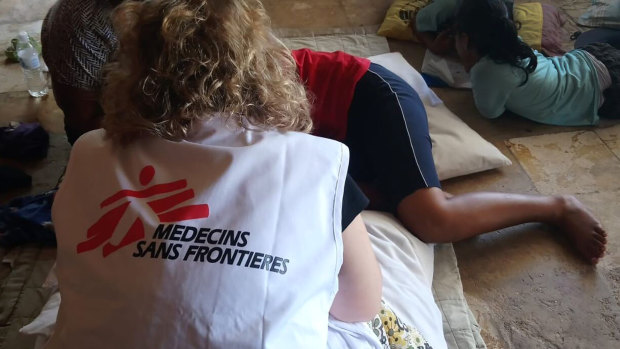 In this October 8, 2018 photo provided by Médecins Sans Frontières Australia, a MSF mental health team attends to a patient in Nauru.