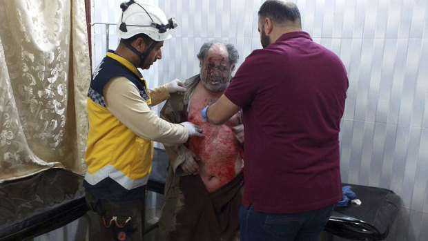 A man injured in an attack on a market receives treatment at a hospital in the village of Ras el-Ain, Idlib province, Syria, last week.