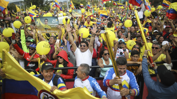 Hometown hero: Fans in Zipaquira celebrate as they watch a giant screen broadcasting Bernal winning the Tour de France.