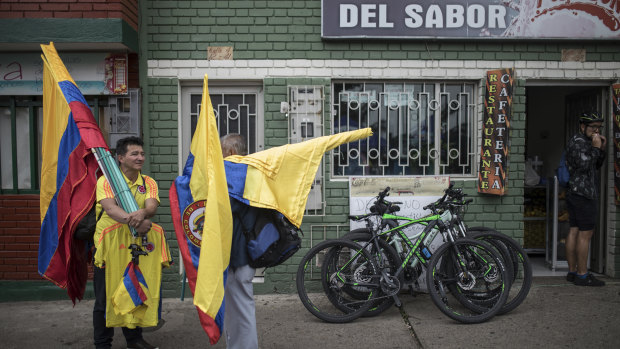 National treasure: Colombian flag vendors wait for costumers at the main square of Bernal's hometown in Zipaquira.