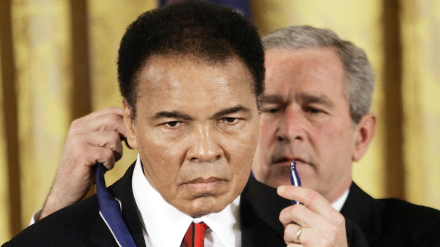 The US president George W Bush presents the Presidential Medal of Freedom to boxer Muhammad Ali in 2009.