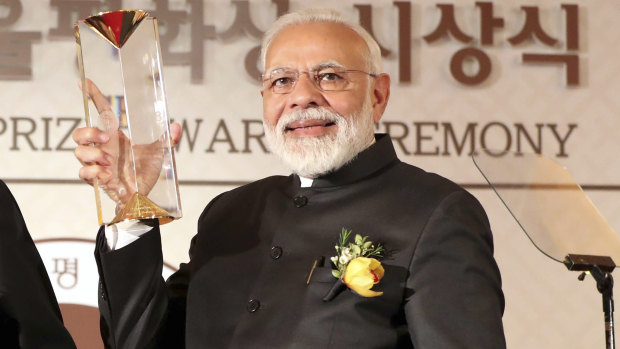 Indian Prime Minister Narendra Modi receives the Seoul Peace Prize during the 14th Seoul Peace Prize award ceremony in Seoul, South Korea, on Friday/
