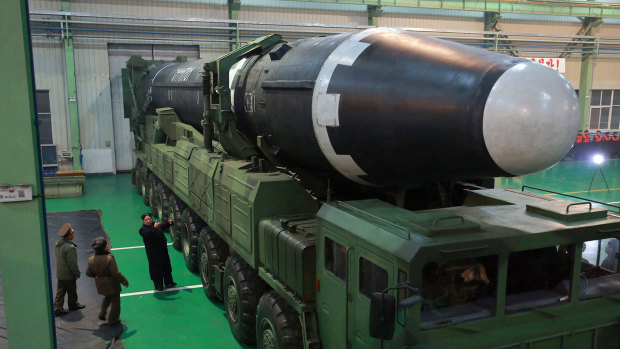 North Korean leader Kim Jong-un, third from left, and what the North Korean government calls the Hwasong-15 intercontinental ballistic missile, in North Korea. 
