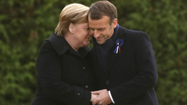 Emmanuel Macron and Angela Merkel unveil a plaque in the Clairiere of Rethondes during a commemoration ceremony for Armistice Day.
