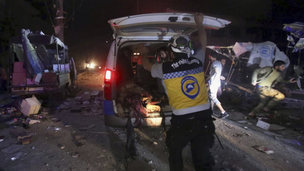 A White Helmet worker loads an injured man into an ambulance after Syrian government airstrikes hit the town of Maaret al-Numan, Idlib province.