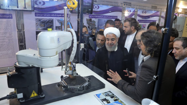 President Hassan Rouhani listens to explanations on new nuclear achievements at a ceremony to mark “National Nuclear Day” in Tehran in 2018. 