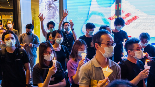 Participants take part in a memorial vigil in a Mongkok in Hong Kong, China. 