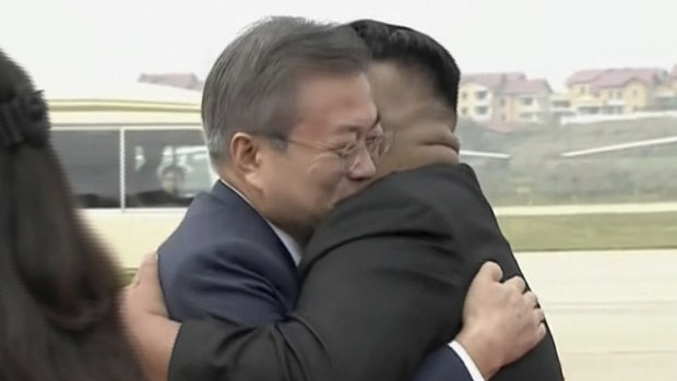 South Korean President Moon Jae-in, left, hugs North Korean leader Kim Jong Un upon arrival in Pyongyang, North Korea, on Tuesday morning.