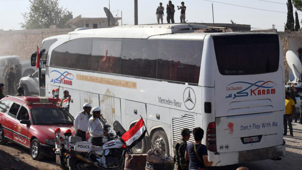Syrians being evacuated in buses from the two pro-government villages to the crossing between Aleppo and Idlib in July.
