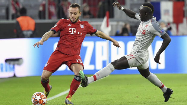 Bayern defender Rafinha (left) duels with Liverpool's Sadio Mane.