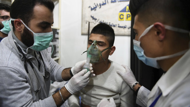 In this photo released by the state-controlled SANA news agency in Syria, a man is said to be receiving oxygen through respirators following an alleged chemical attack on al-Khalidiya, near Aleppo, on Saturday.