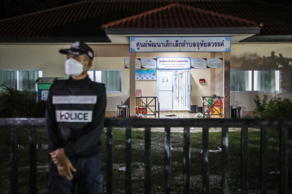 A police officer stands guard outside the childcare centre. 